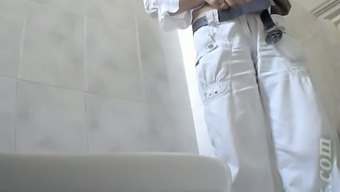 Stranger chick in white pants pisses in the public toilet room