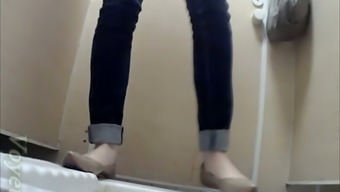 Pale skin slim white teen babe in jeans pisses in the toilet