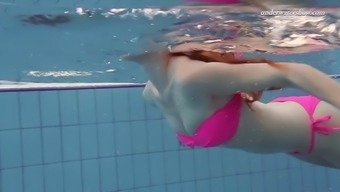 lovely lera takes her pink swimsuit in a swimming pool