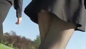 Teen in short black skirt and black stockings upskirt