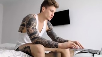 Sexy tattooed hunk strokes his big shaft on the webcam