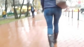 MILF's ass in tight jeans in rainy day
