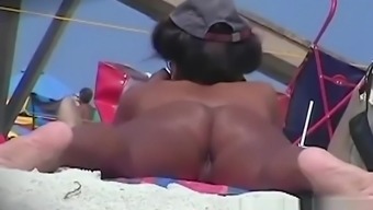 Naked hotties followed around by a nude beach voyeur