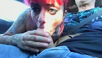 Tattooed busty emo girl Candy Doll is busy with jerking cock in the car