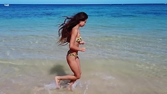 Pretty young model in bikini is posing on the beach
