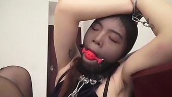 Chinese girl in pantyhose and mask in bondage