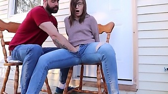 A bearded perv jerks off his girlfriend's pussy on the porch until she squirts