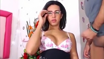 Big tits and glasses add to the fun of this shemale's anal play
