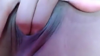 Intimate homemade video of a brunette woman stimulating her clitoris on camera